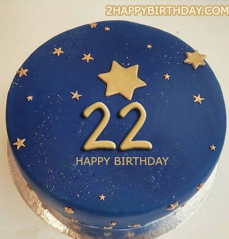 a blue birthday cake with gold stars and the number 22 on it's side