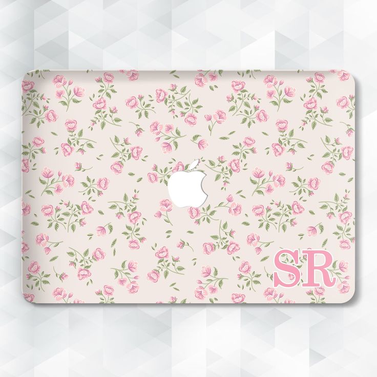 an apple laptop with pink flowers on it and the word sr in front of it