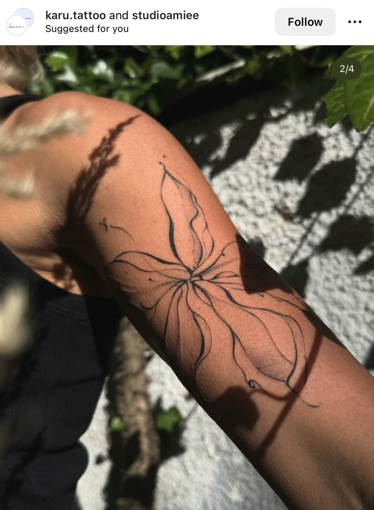 a woman's arm with a tattoo on it that has a flower in the middle