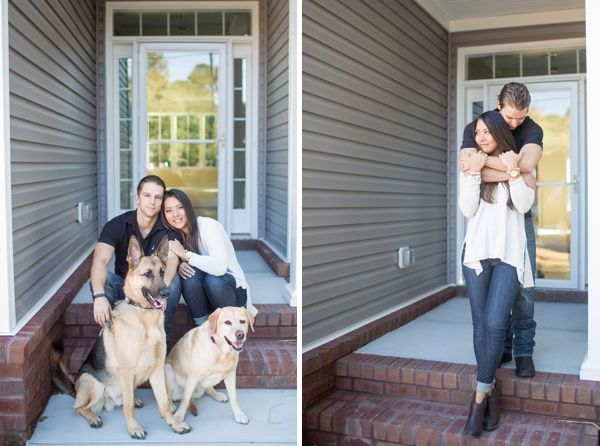 a man and woman sitting on the steps with their two dogs in front of them