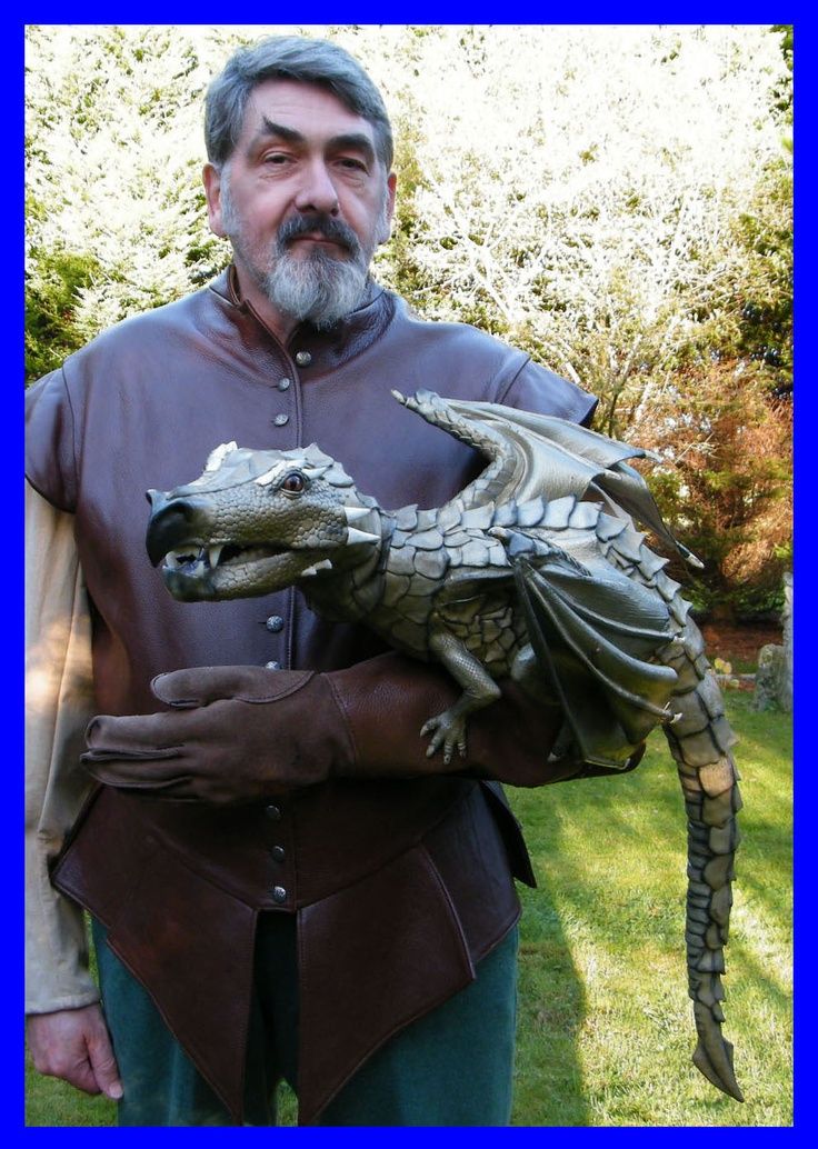 a man holding an alligator statue in his hands