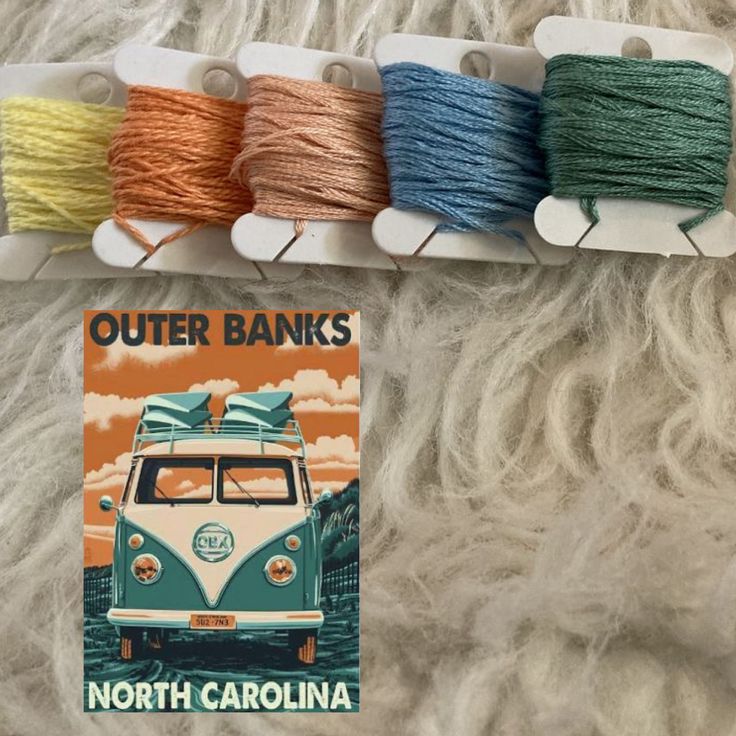 there are many different colored yarns on the shelf next to each other and one has a vw bus in it