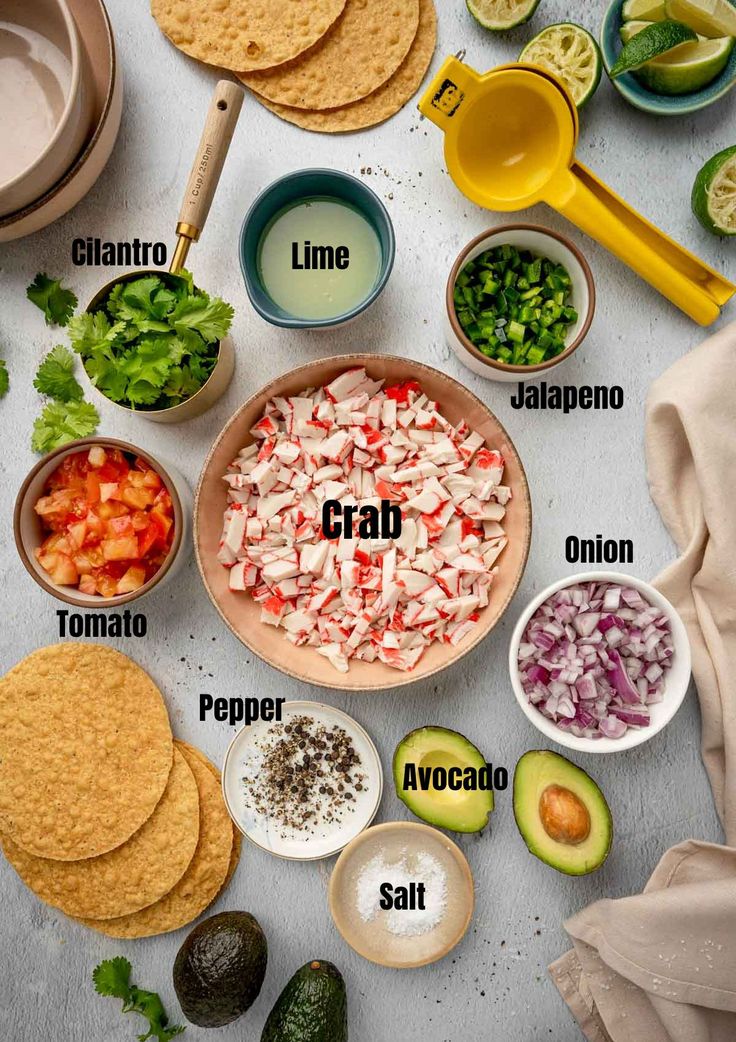 the ingredients to make an enchilada recipe laid out on a white table