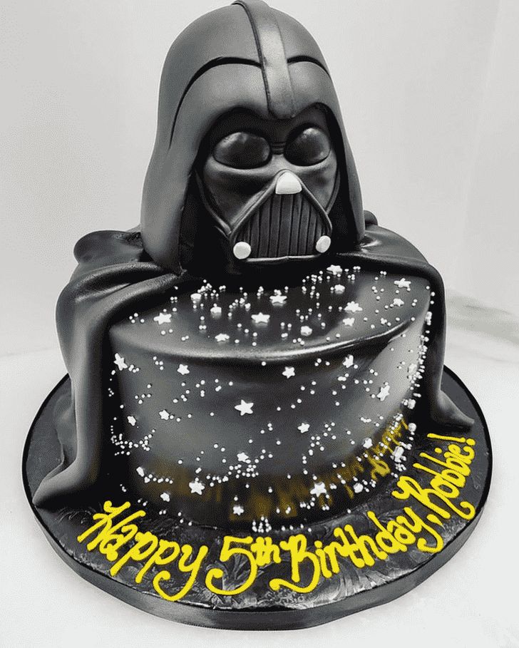 a darth vader birthday cake with stars and sparkles on the bottom layer