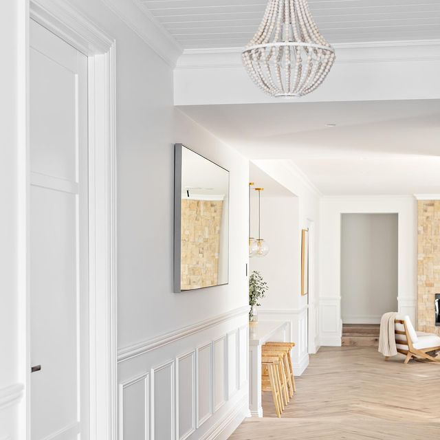 an empty living room with white walls and wood flooring is seen in this image