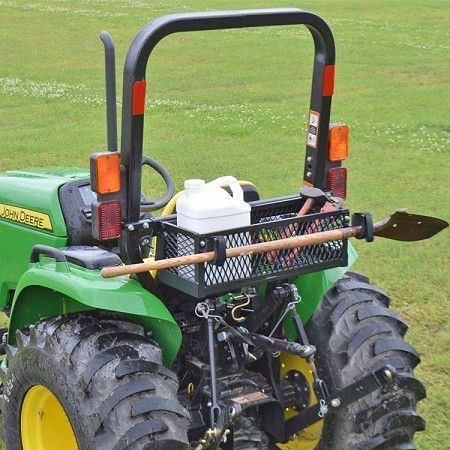 a large green tractor parked on top of a lush green field