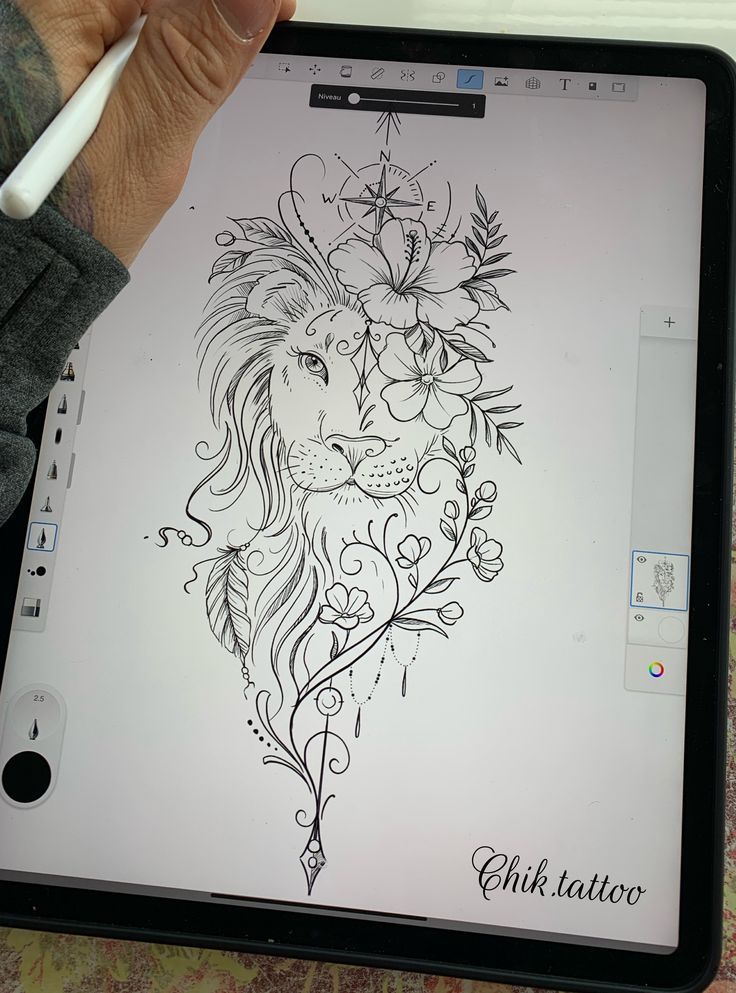 a person is drawing on an ipad with a pen and inking it in the shape of a lion's head