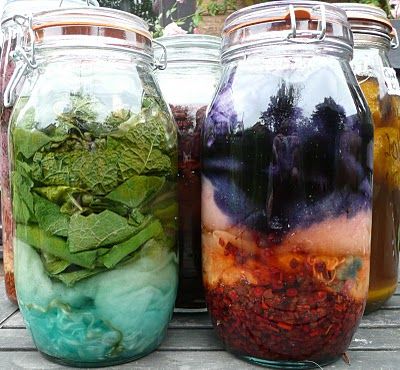 three jars filled with different types of food on top of a wooden table next to each other