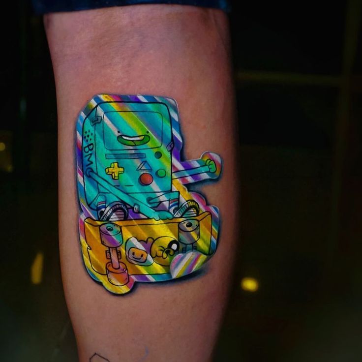 a colorful tattoo on the leg of a person with a skateboard painted on it