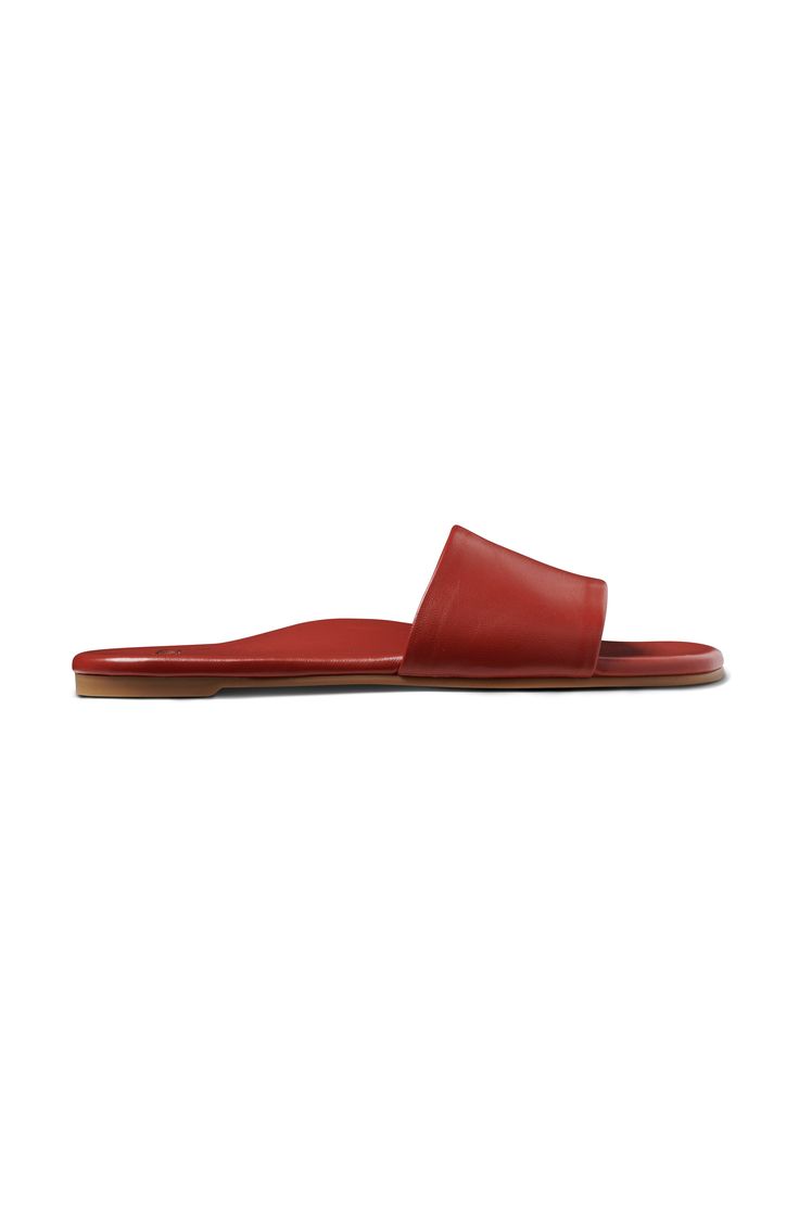 Introducing the HONEYBIRD leather slide sandal, a fusion of feminine style and comfort designed for your everyday adventures. Crafted with meticulous attention to detail, these sandals boast a luxurious leather-wrapped memory foam insole and a durable rubber outsole with a subtly squared toe shape for a contemporary flair. The memory foam provides unparalleled cushioning, ensuring every step is a blissful experience, while the molded arch offers all-day support, making these sandals ideal for ex Leather Slides With Rubber Sole, Red Slide Sandals With Rubber Sole, Classic Red Leather Sandals, Classic Open Toe Slides With Rubber Sole, Red Open Toe Sandals With Leather Lining, Leather Sole Slides For Vacation, Classic Red Open Toe Sandals, Classic Slides With Rubber Sole, Classic Sandals With Red Sole