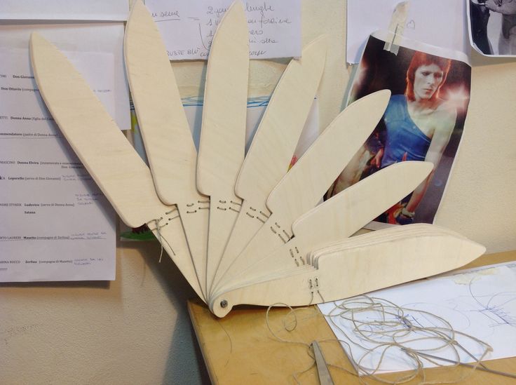 several pieces of wood sitting on top of a wooden table next to papers and scissors