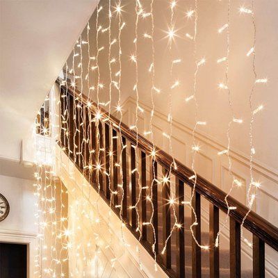 some lights that are on the side of a staircase