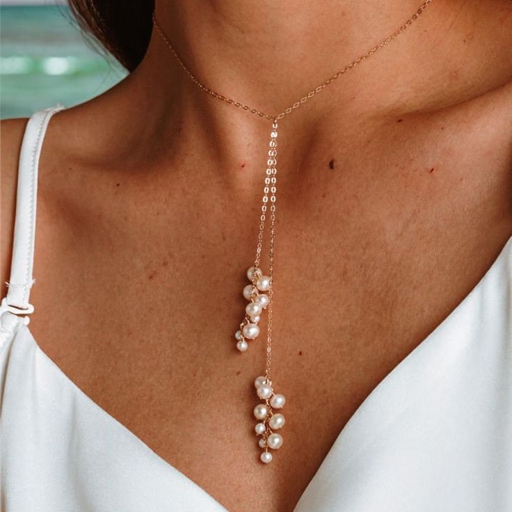 Enhance your jewelry collection with our sophisticated Pearl Drop Necklace, crafted with 14K gold filled metal and a lustrous natural freshwater pearl pendant. This elegant piece is designed to add a touch of refinement to any outfit, making it perfect for everyday wear or special occasions. ✨ Details: Metal: 14K Gold Filled Main Stone: Freshwater Pearl Pearl Type: Natural Freshwater Pearls Item Weight: Approx. 1g Style: Elegant, Simple Layering, Y Necklace, Bridesmaid Necklace This exquisite ne Gold Pearl Necklace With Clavicle Chain Dangle, Pearl Lariat Backdrop Necklace As Gift, Gold Pearl Chain Backdrop Necklace, Gold Pearl Charm Backdrop Necklace, Gold Pearl Drop Backdrop Necklace, Gold Backdrop Necklace With Pearl Charm, Gold Backdrop Necklace With Pearl Drop, Gold Backdrop Necklace With Pearl Pendant, Gold Lariat Pearl Necklace With Pendant