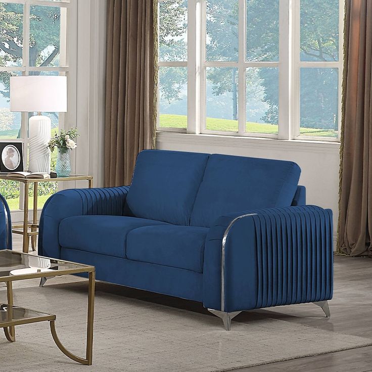 a living room with two blue couches in it