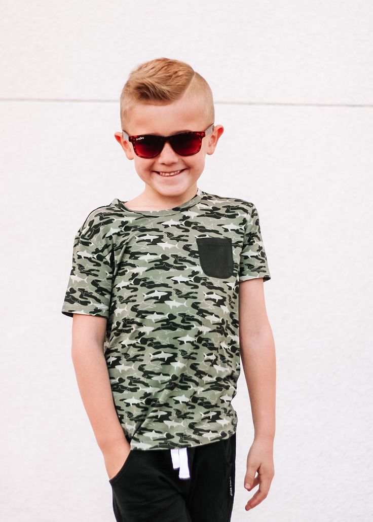 Our Camo Shark Dream Pocket Tee is sure to be a hit with the boys! Keep them looking cool with its fun camo shark print and stylish short sleeve pocket tee. Crafted with bamboo material for the perfect look and feel. Ready to take a bite out of style? Dive in! Made from the softest and most breathable seasonal bamboo viscose material, your babe won't want to take this off! Designed for all the love and extra snuggles! Sleep and play with zero irritation with our tag-less DreamyZzz! Available in Toddler Flower Girls, Girls Gloves, Shark Print, Girls Dress Outfits, Toddler Flower Girl Dresses, Infant Flower Girl Dress, Bamboo Material, Tea Party Dress