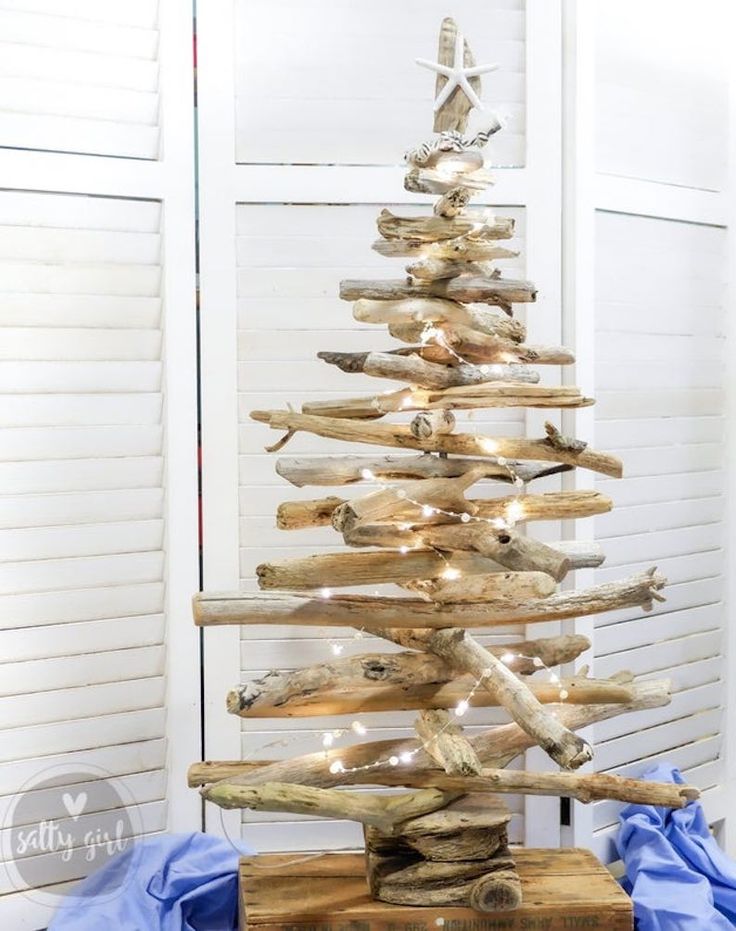 a wooden christmas tree made out of driftwood