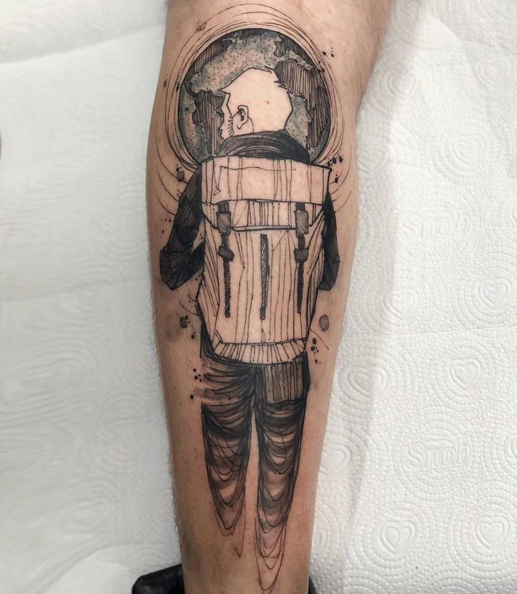 a man's leg with an astronaut tattoo on it