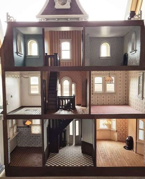 the inside of a doll house with stairs and windows