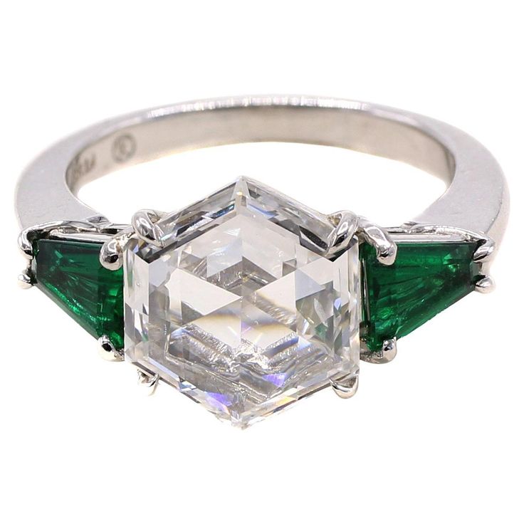 This truly unique engagement ring features a GIA certified 2.19 carat hexagonal mixed cut diamond. The GIA report gives this gemstone a color grade of F and a clarity of SI1. The unusual cut of this diamond has the top facets as a step-cut where as the pavilion ( bottom ) facets have brilliant facets. The combination produces a mesmerizing effect of tranquiller brilliancy . This diamond is also much spreadier in its dimensions as similar round diamonds of the same size. Set in a beautiful handcr Elongated Hexagon Engagement Ring, Hexagon Engagement Ring, Hexagonal Ring, Platinum Engagement Ring, The Pavilion, Hexagon Diamond, Ring Styles, Unique Engagement Ring, Jewels Rings