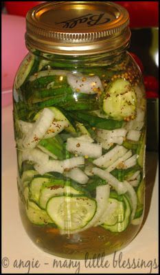 a mason jar filled with sliced cucumbers and onions