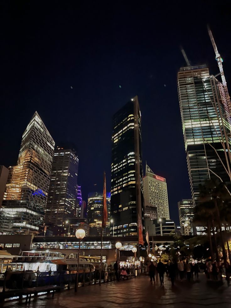 the city skyline is lit up at night