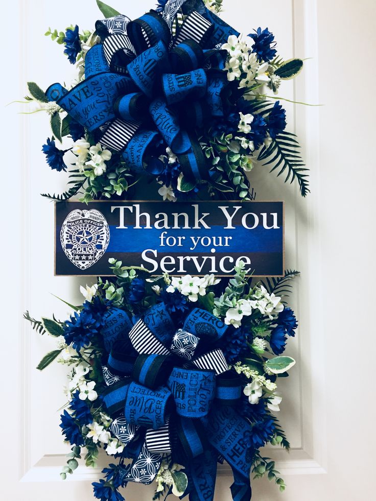 a blue and white wreath with the words thank you for your service