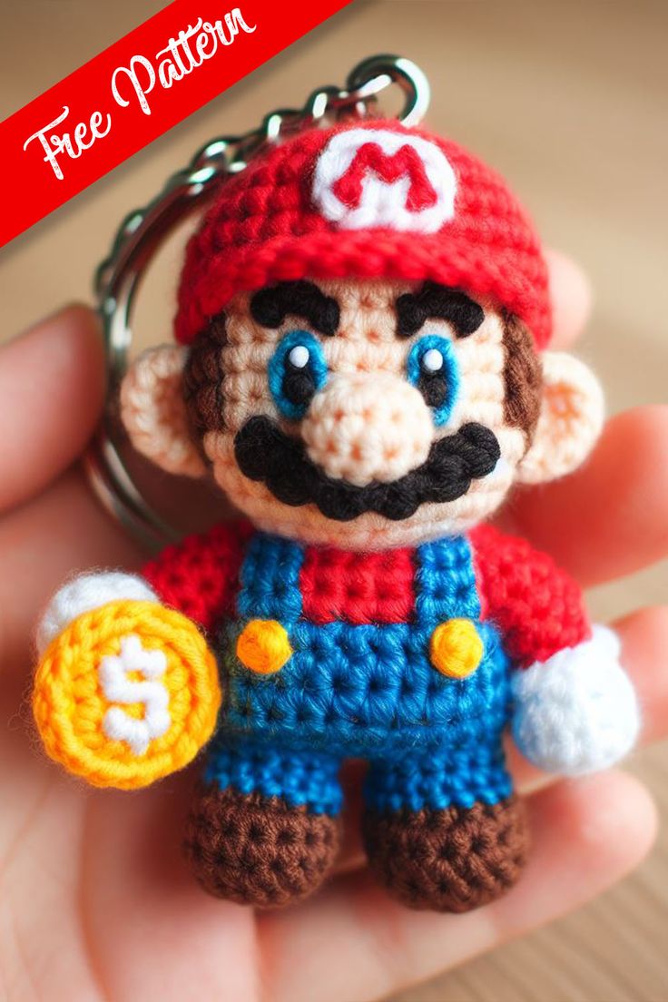 a crocheted mario keychain is shown in the palm of someone's hand