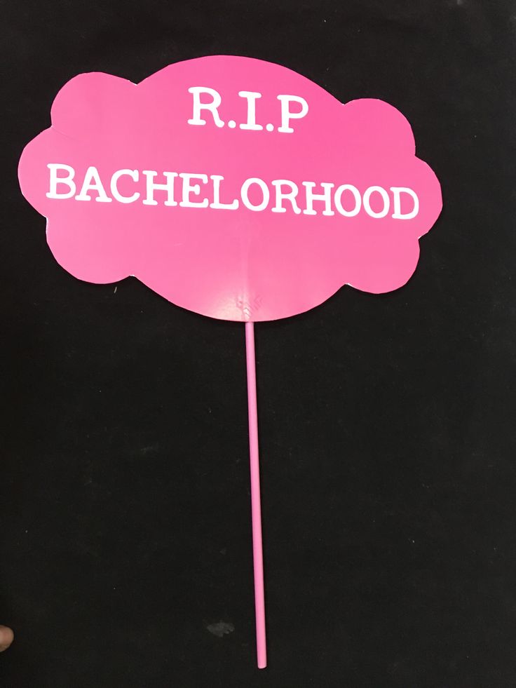 a pink stick with the words r i p bachelorhood on it and a cloud