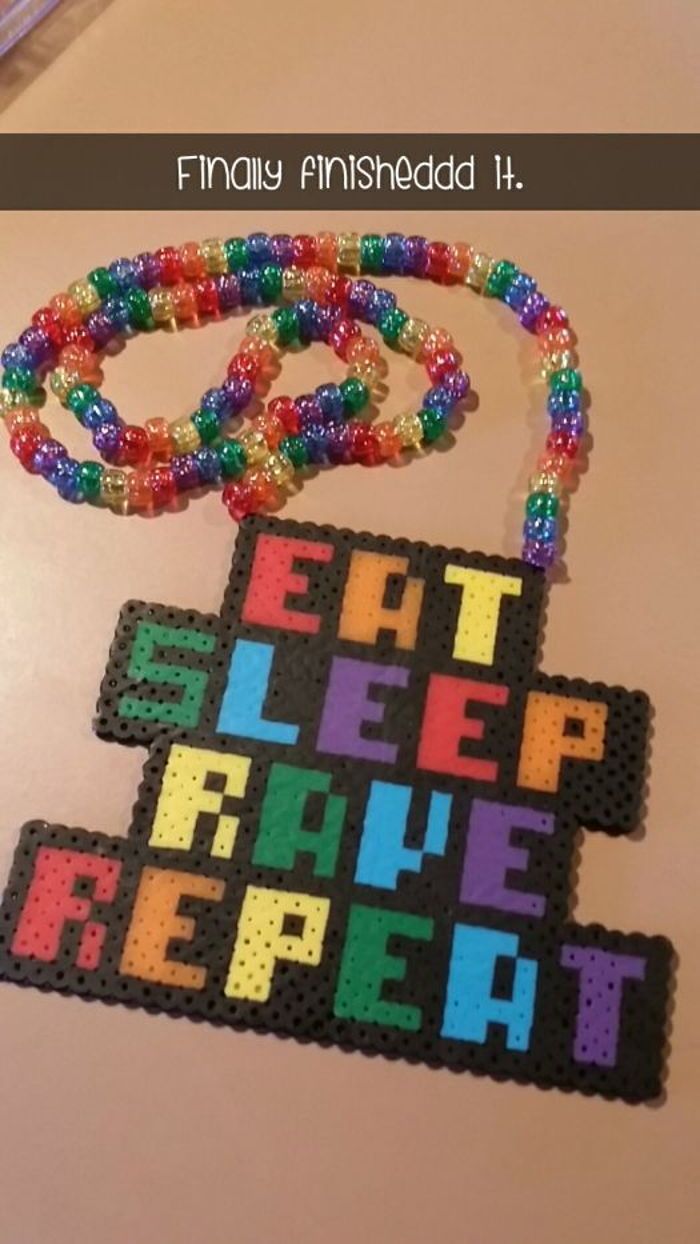 a beaded necklace with the words eat sleep repeat on it and an image of a crossword puzzle