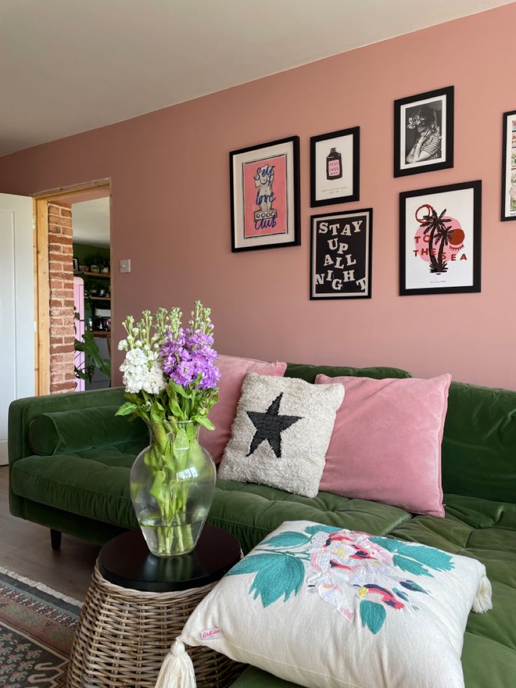 a living room filled with furniture and pictures on the wall