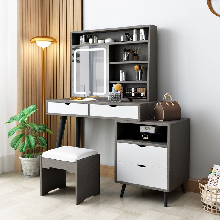 a white and black desk with drawers, a stool and a mirror