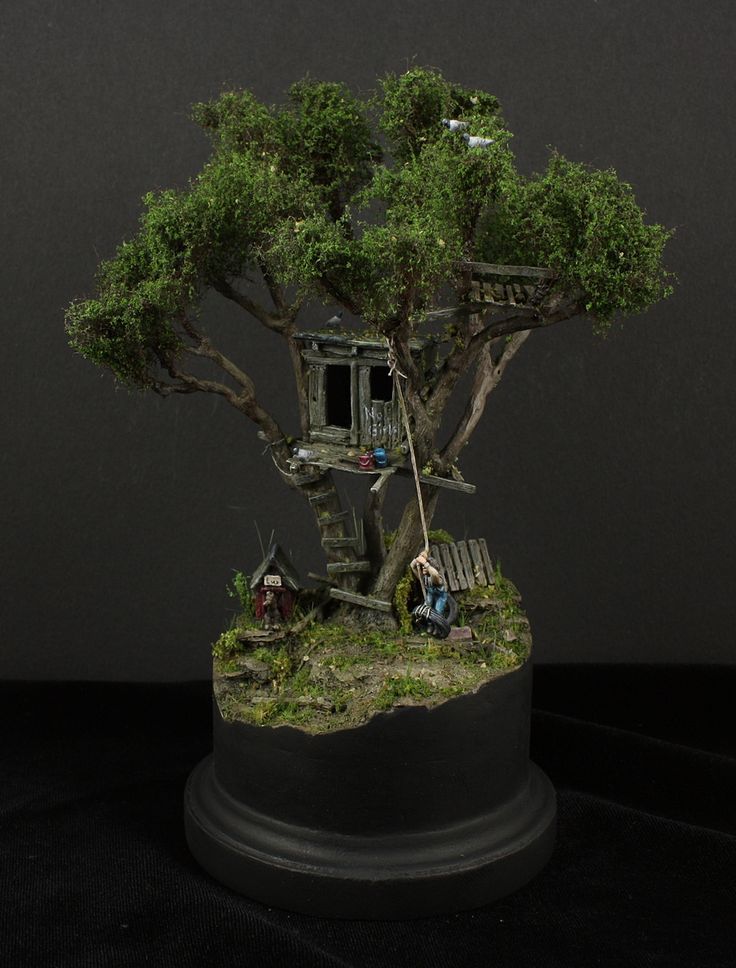 a miniature tree house is on display