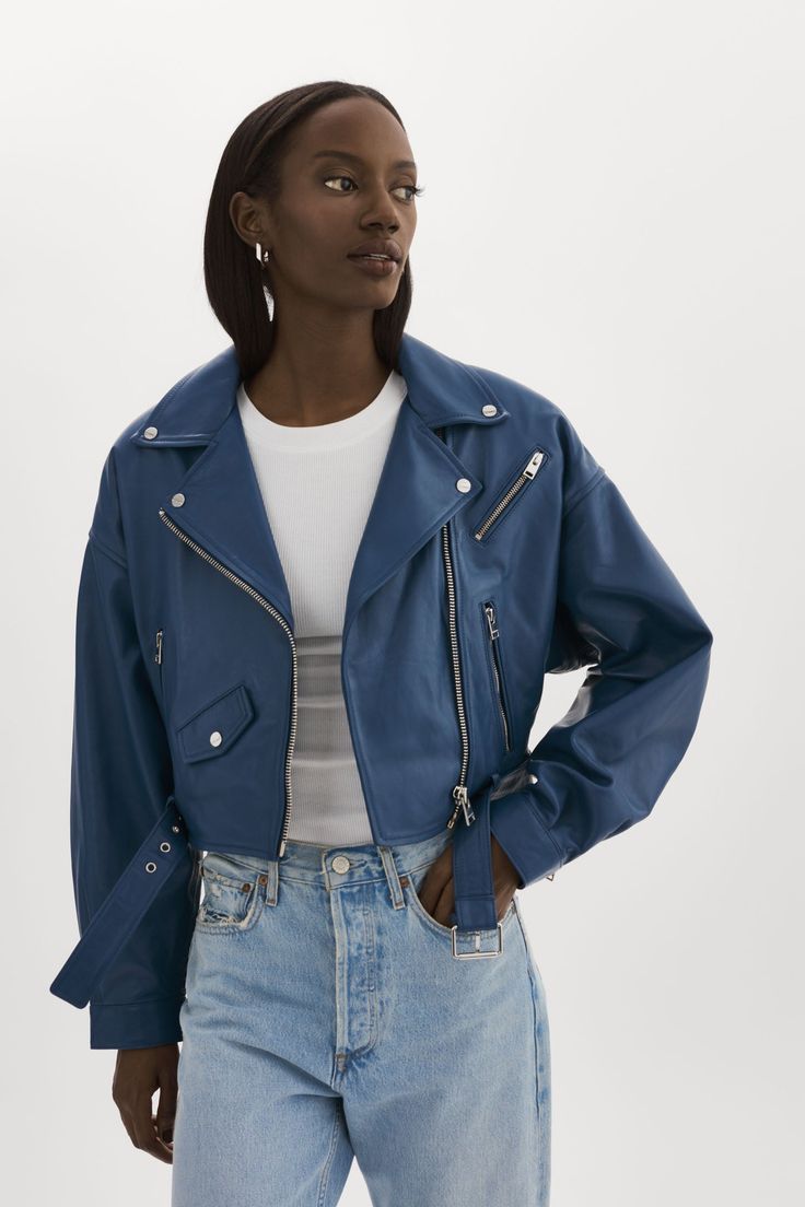 Sometimes, there's no better feeling than commanding the room. Bring back the best of the 80s with this vintage-inspired cropped leather jacket. Featuring classic biker elements and unexpected stand-outs like shoulder pads and balloon pleated sleeves, you'll stand out from the rest when you rock the Dylan. A coin flap pocket and a removable waist belt add unique touches to this lamb leather stunner. A true statement piece, this 80s leather jacket is an instant head-turner. Blue Leather Jacket Outfit, Navy Blue Leather Jacket, Navy Leather Jacket, 1980s Costume, Blue Leather Jacket, Leather Outerwear, Cropped Leather Jacket, Pleated Sleeves, Leather Jacket Outfits