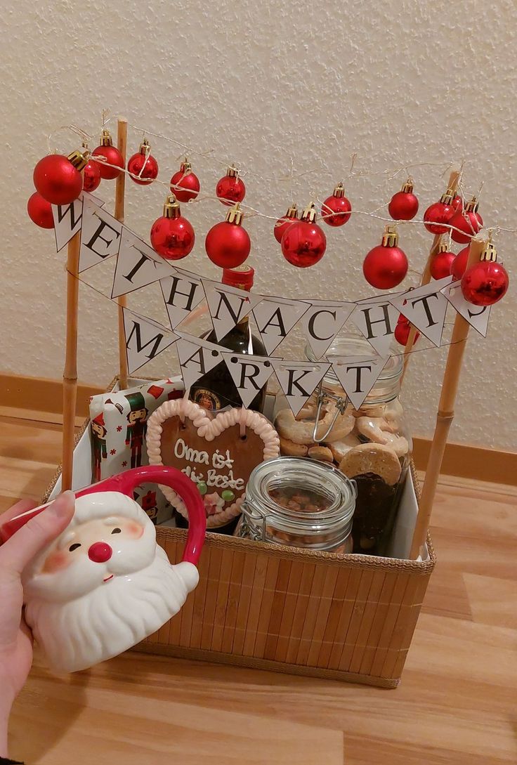 a basket filled with lots of different types of christmas decorations and ornaments on top of a wooden table