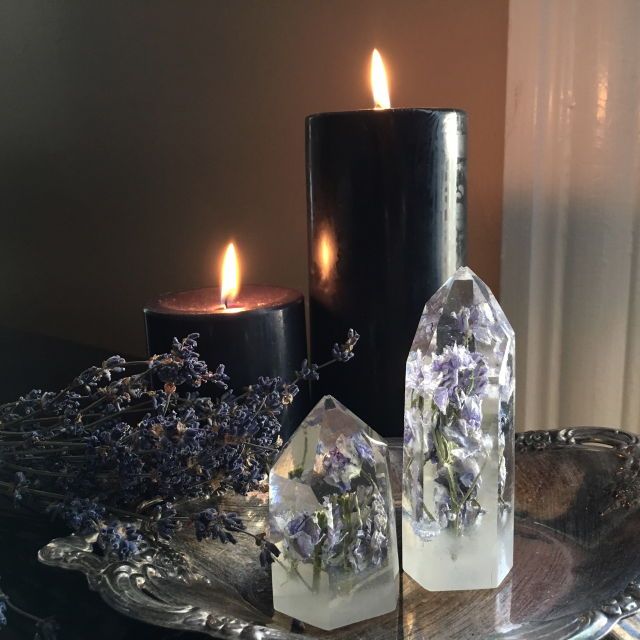 two candles sitting on top of a glass plate