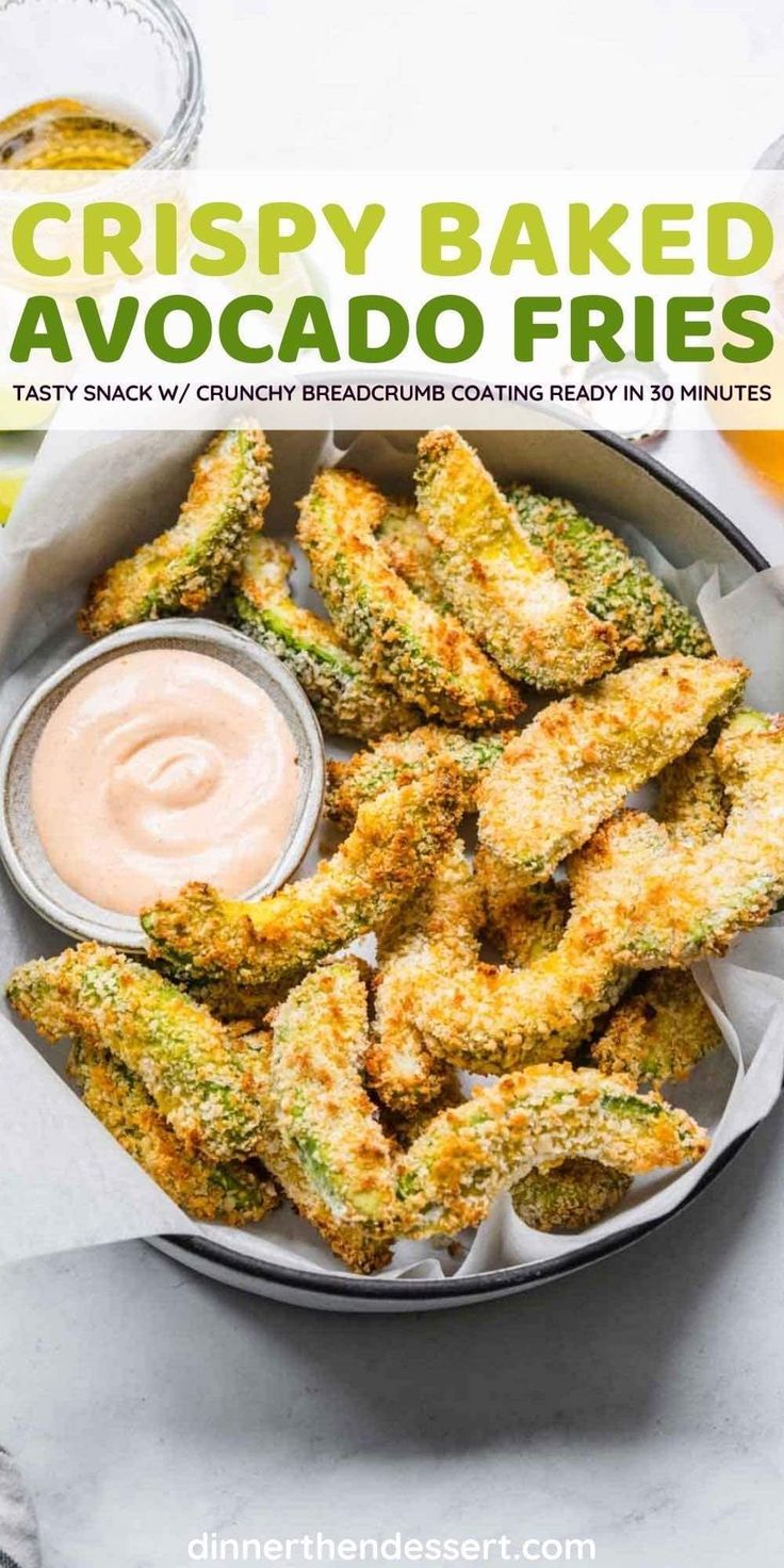 crispy baked avocado fries in a bowl with dipping sauce on the side