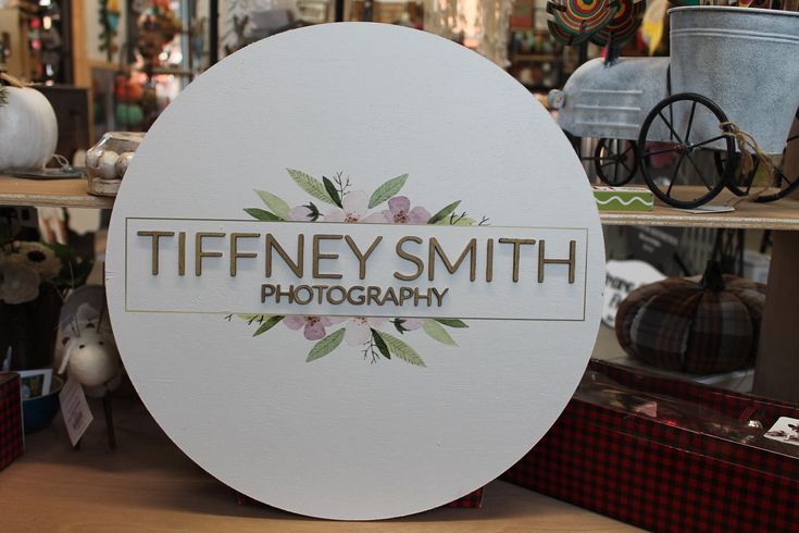 there is a sign that says tiffeney smith photography in front of some other items