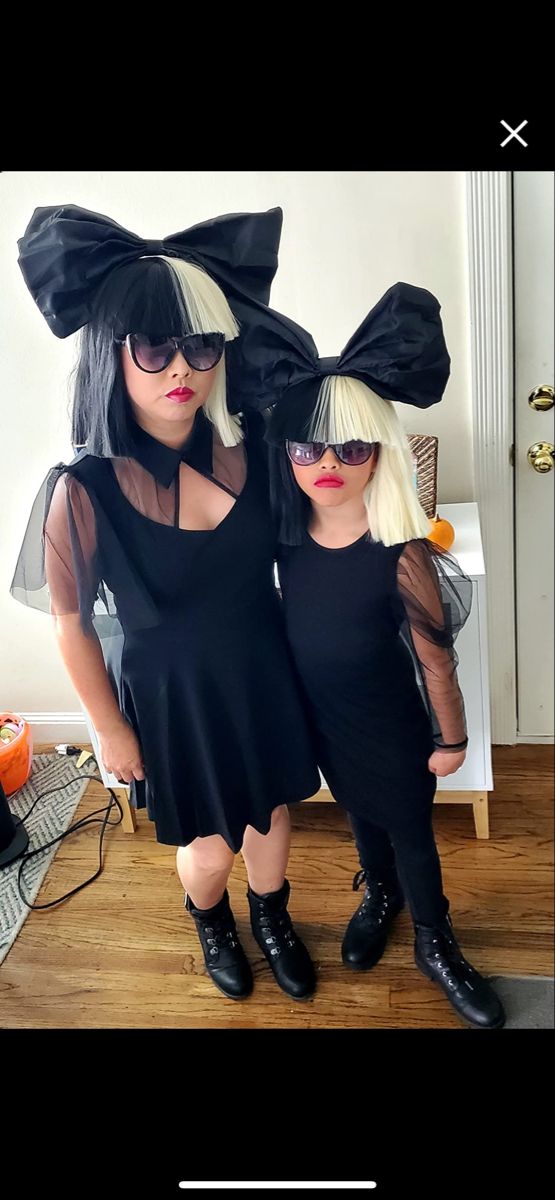 two women dressed up in black and white outfits