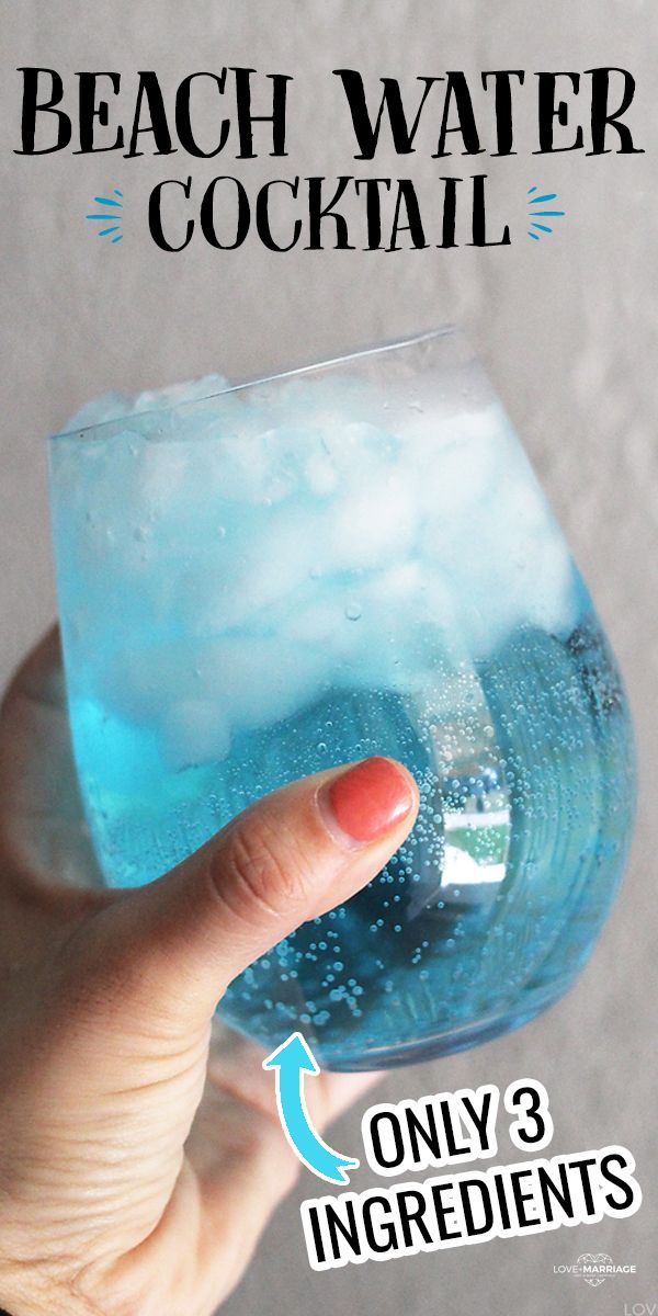 someone holding up a glass with blue liquid in it and the text beach water cocktail only 3 ingredients