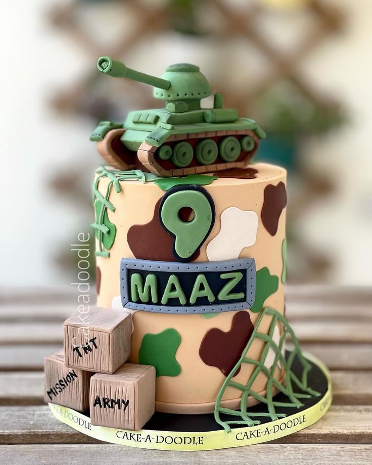 a birthday cake made to look like a tank with the name maza on it