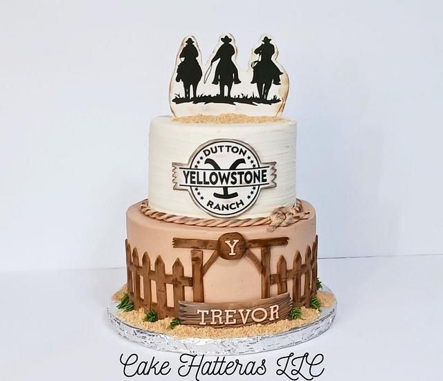 a three tiered cake with cowboy themed frosting on the top and bottom layer