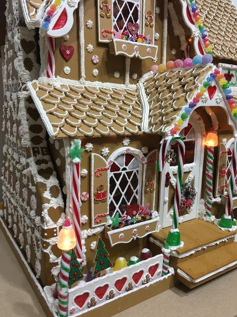 a large gingerbread house with lights and decorations