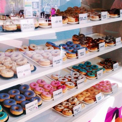 a display case filled with lots of different types of donuts