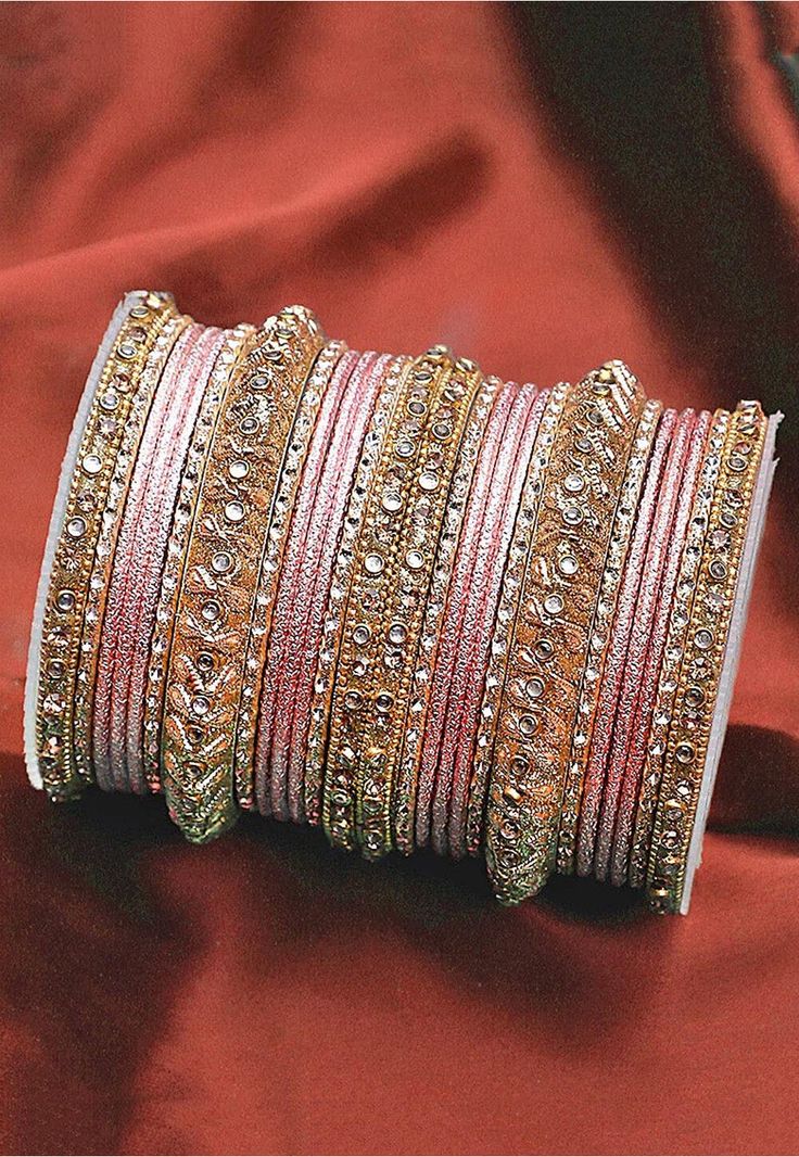 Alloy Based Bangles in Pink and Golden Allured with Stones This set consists of 26 Bangles Pink Bangles, Indian Wedding Jewellery, Indian Wedding Jewelry Sets, Indian Pink, Fancy Jewellery Designs, Utsav Fashion, Wedding Jewellery Collection, Bangles Indian, Beaded Jewellery