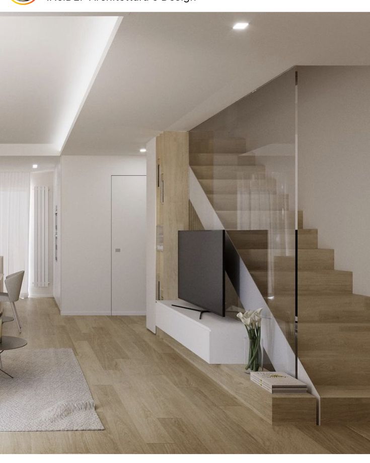 a living room filled with furniture and a flat screen tv sitting on top of a wooden floor