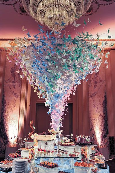 an elaborately decorated dessert table with blue and white decorations