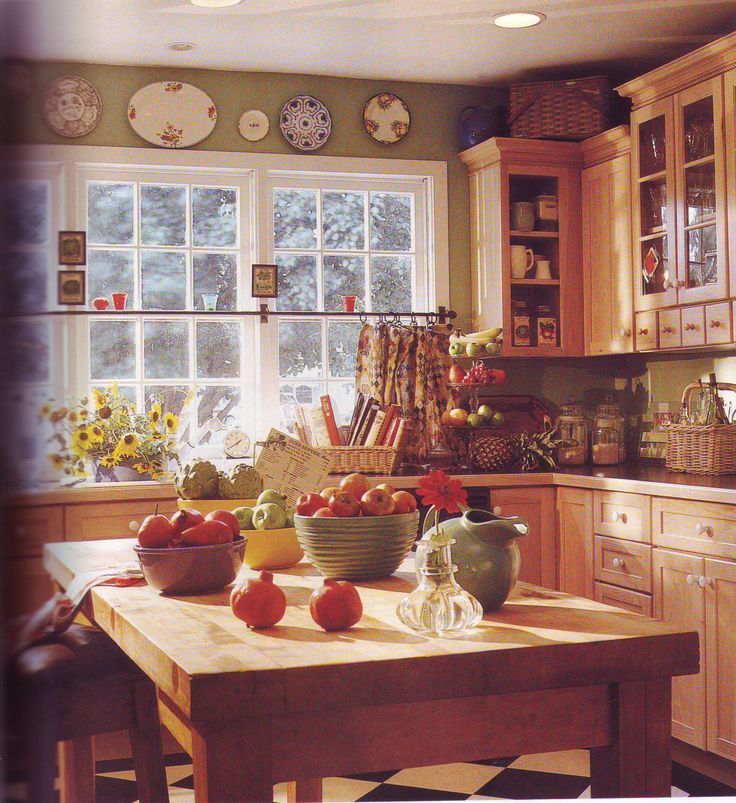 a kitchen filled with lots of wooden cabinets and counter top space next to a window