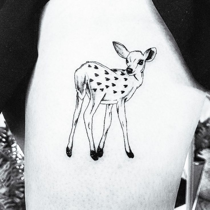 a black and white photo of a deer tattoo