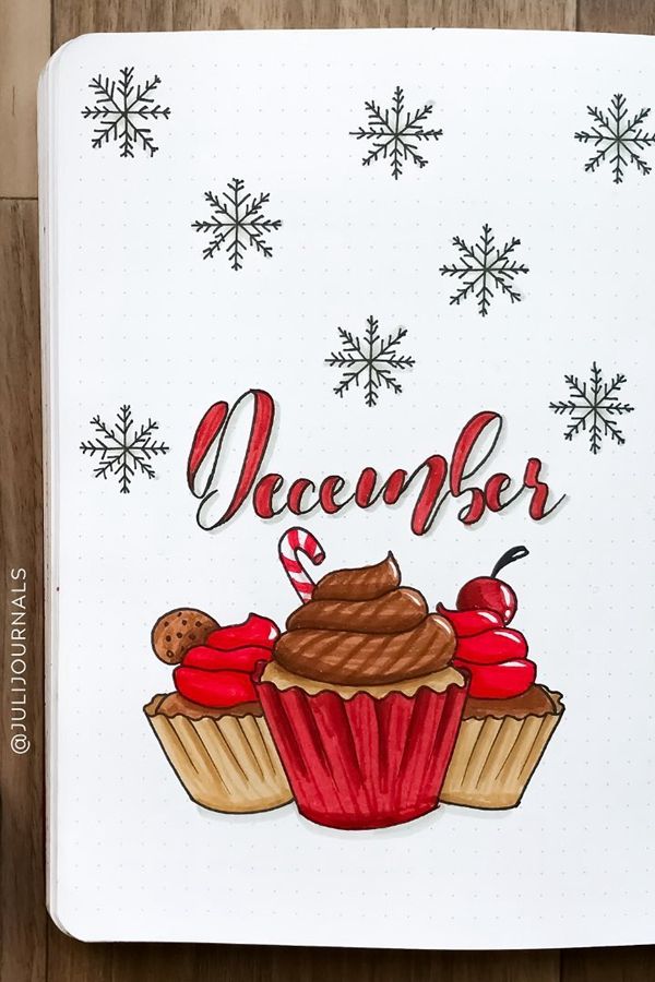 an open notebook with the words december and cupcakes in red, white and brown