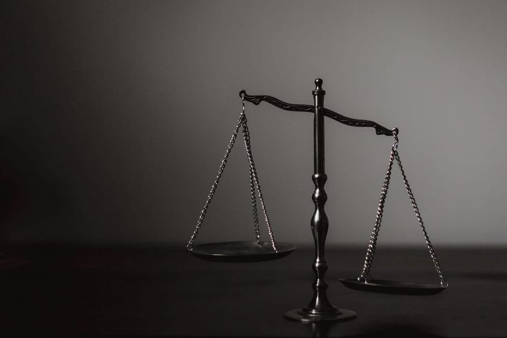 an old fashioned scale with two balances on each side, sitting on a table